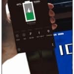 Hand holding a phone with Ionic app pulled up on the screen, with 12 Volt 100Ah Lithium Deep Cycle Battery in the background.