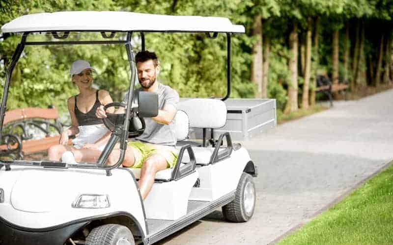 couple riding golf cart