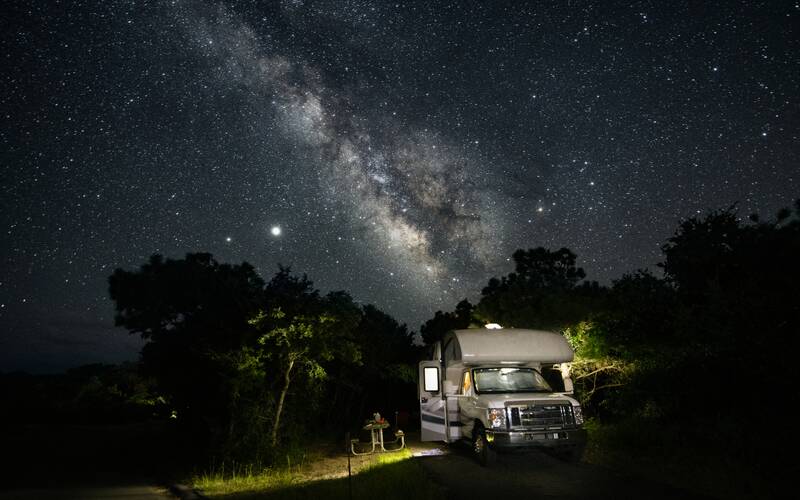 Boondocking in RV at night under the stars.