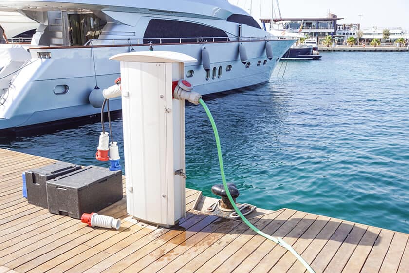 Image of a marine battery charger near a docked boat.