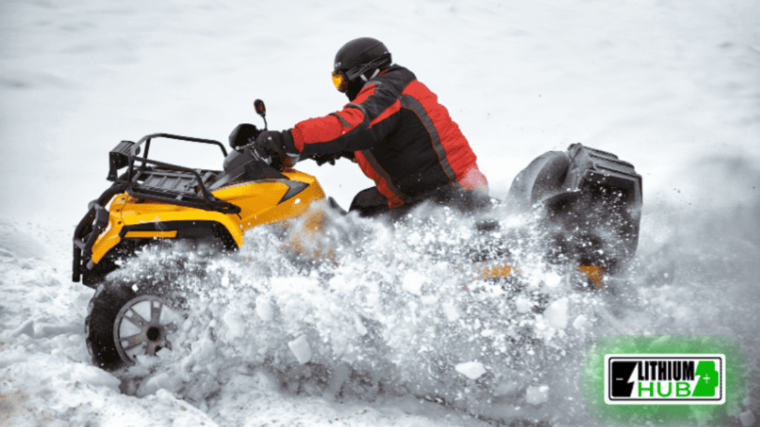 Man driving a yellow ATV in the snow.