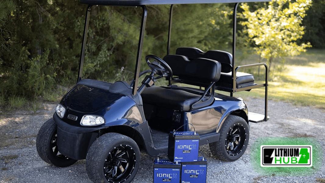 Golf cart on a golf course path with three Ionic lithium batteries with battery protection beside it on the path.