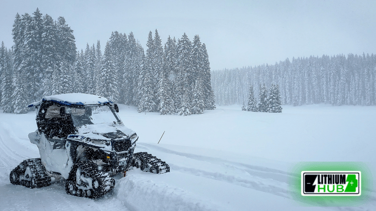Image of a UTV navigating through a snowy landscape, showcasing its capability in winter conditions.