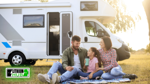 A family enjoys a sunny day on the grass in front of their RV, creating cherished memories together outdoors.