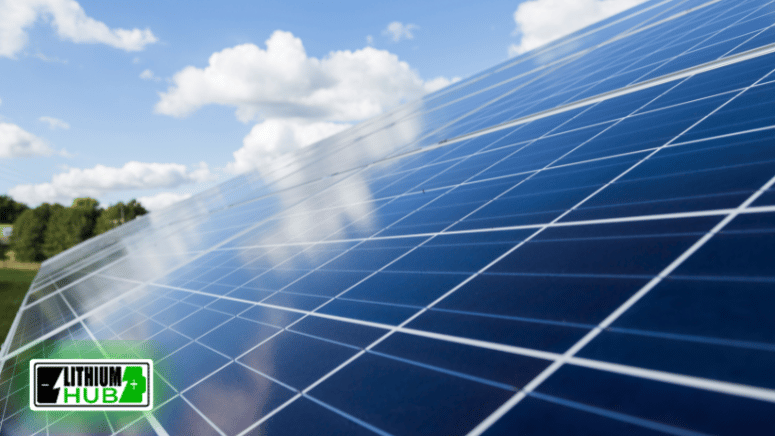 Solar panels arrayed on a vibrant green field beneath a clear blue sky, representing eco-friendly energy generation.