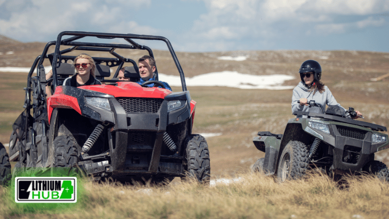People enjoying an exhilarating ride on ATVs amidst scenic mountain views, embodying the spirit of outdoor adventure.