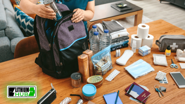 A person sets their backpack on a table, which features an emergency kit, indicating readiness for emergencies.