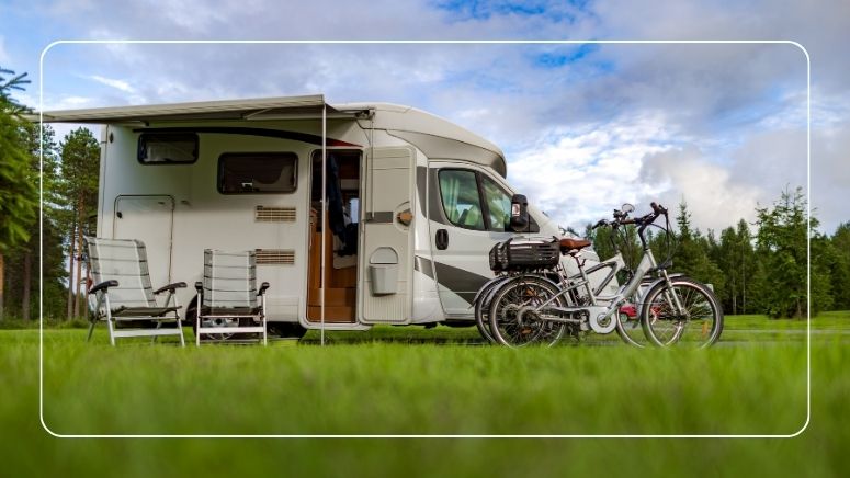 A travel trailer driving through a red rock canyon landscape alongside an Ionic LiFePO4 lithium battery