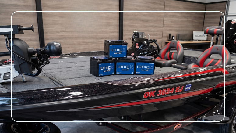 Four Ionic LiFePO4 deep cycle lithium batteries on a bass boat deck in a garage workshop