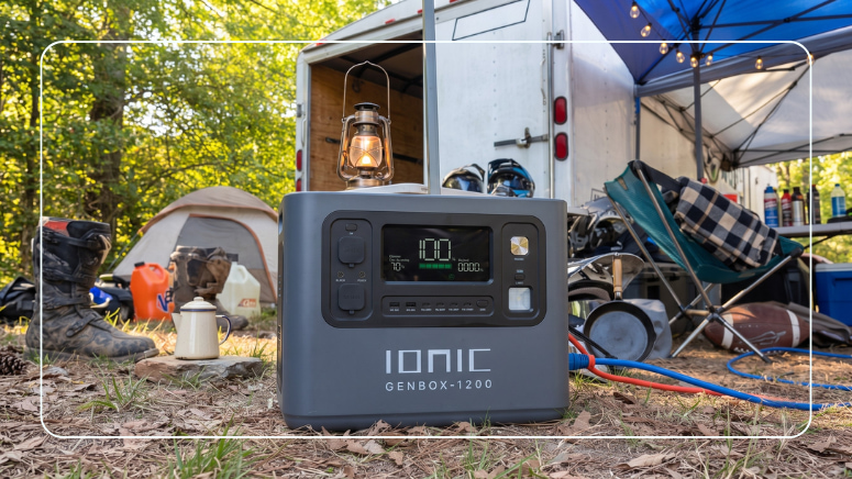 Lithium portable power station powering lights at a busy campground with a tent, trailer, and canopy