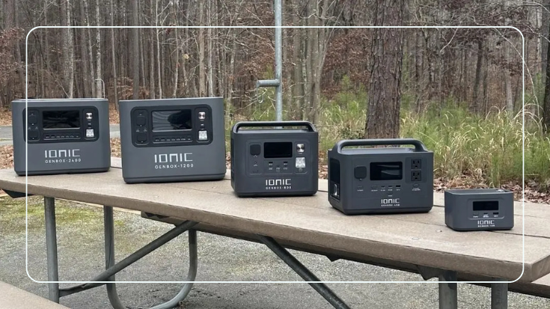 Ionic GenBox portable power station lineup from GenBox 100 to GenBox 2400 lined up on an outdoor picnic table