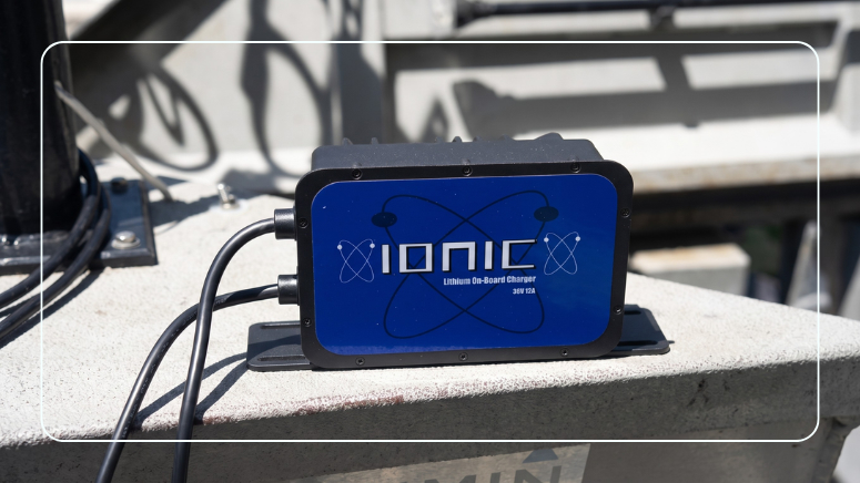 Ionic 36V 12A lithium on-board marine battery charger mounted on a boat with charging cables connected