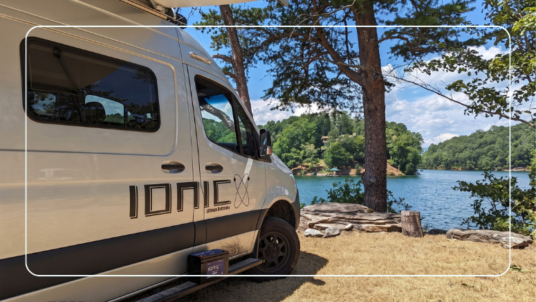 Ionic lithium batteries powering a camper van at a lakeside campsite for dependable off-grid RV power
