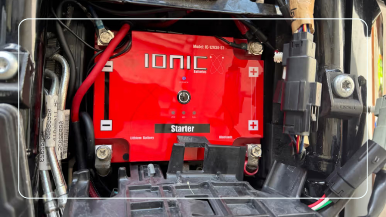 Ionic lithium motorcycle starter battery with Bluetooth installed in a Harley battery compartment with clean, tight terminal connections