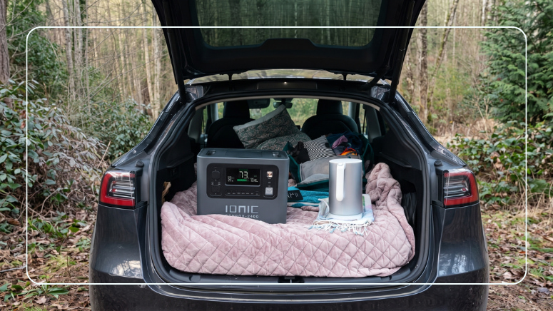 Ionic GenBox 2400 portable power station with an electric kettle in the cargo area of an SUV