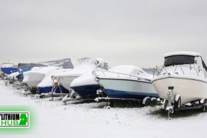 Lake and boats in marina in the winter, with LithiumHub logo on the side of the image.