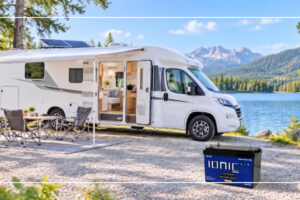 Camper van with rooftop solar panels parked by a mountain lake with an Ionic lithium RV battery
