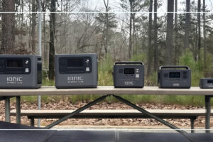 Full Ionic GenBox portable power station lineup arranged by size on an outdoor picnic table